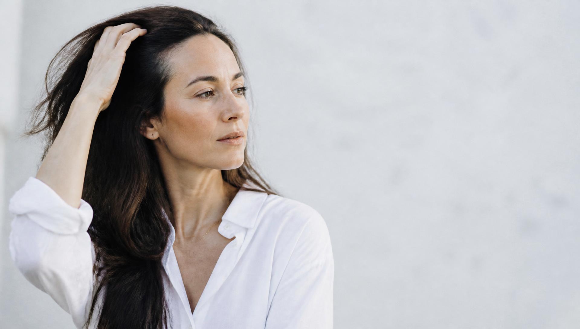 Woman running her hand through healthy hair — Hair by DrThriveRx