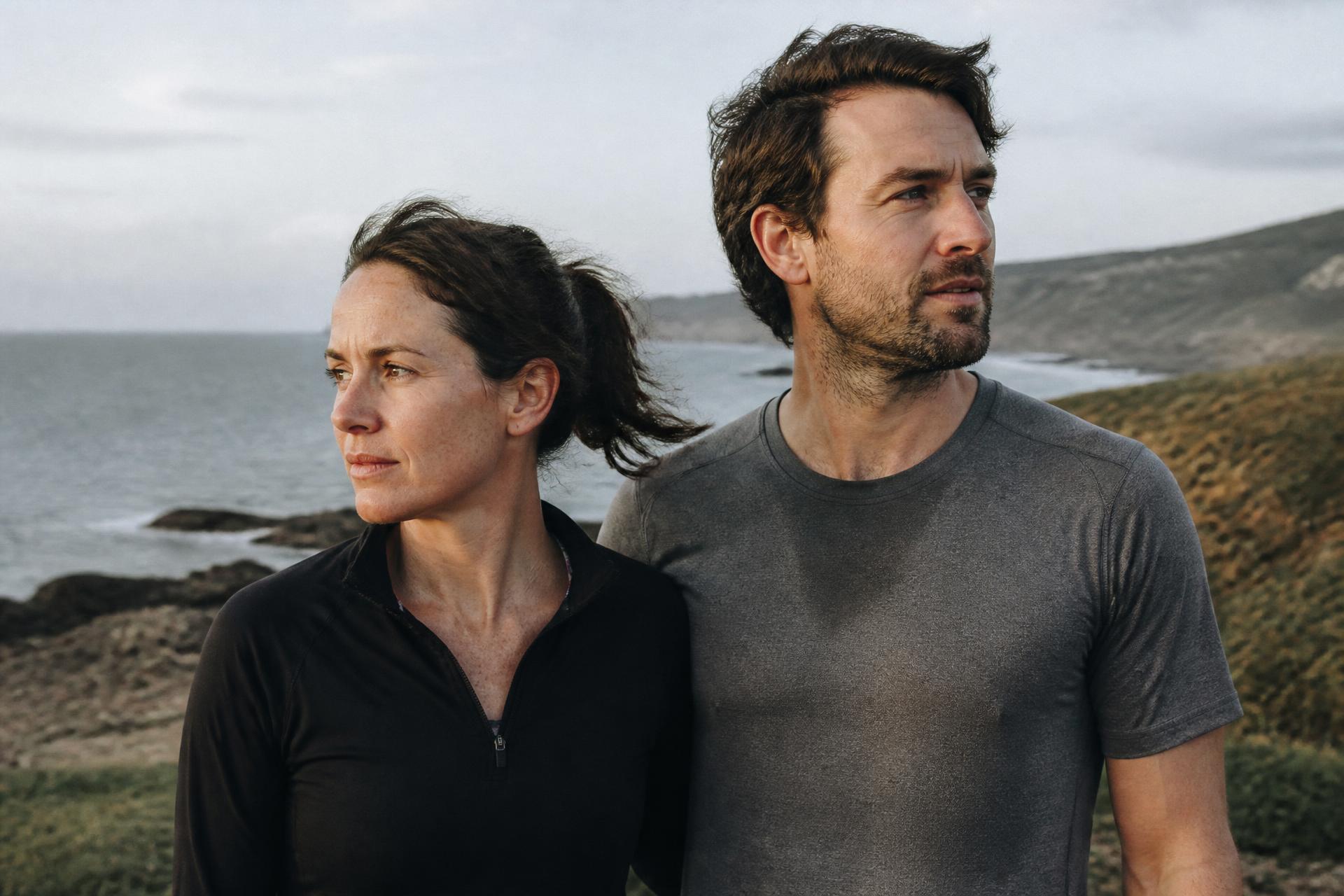 Couple on a coastal trail after a run in natural daylight